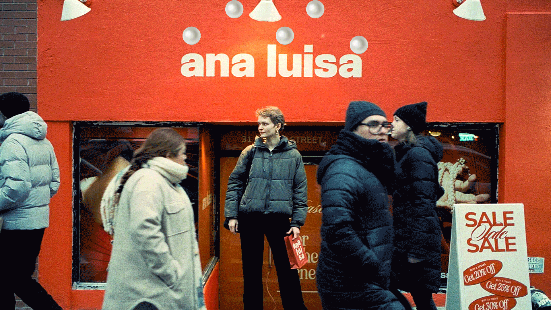 Anni Jürgenson standing in front of Ana Luisa jewelry shop in NYC with Ana Luisa bag in hand for Trickster Magazine